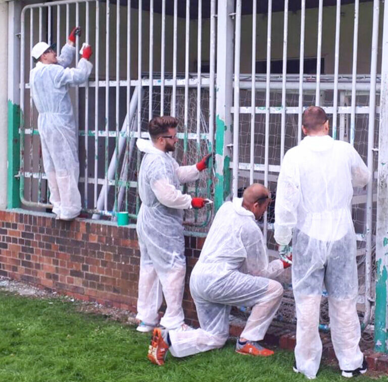 Volunteers Painting White Railings